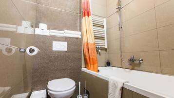 Un baño con inodoro, ducha y bañera.