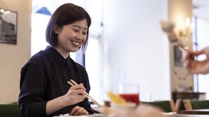 A person seated at a table in a restaurant, holding chopsticks. - Ariston Hotel Kobe (Kobe)
