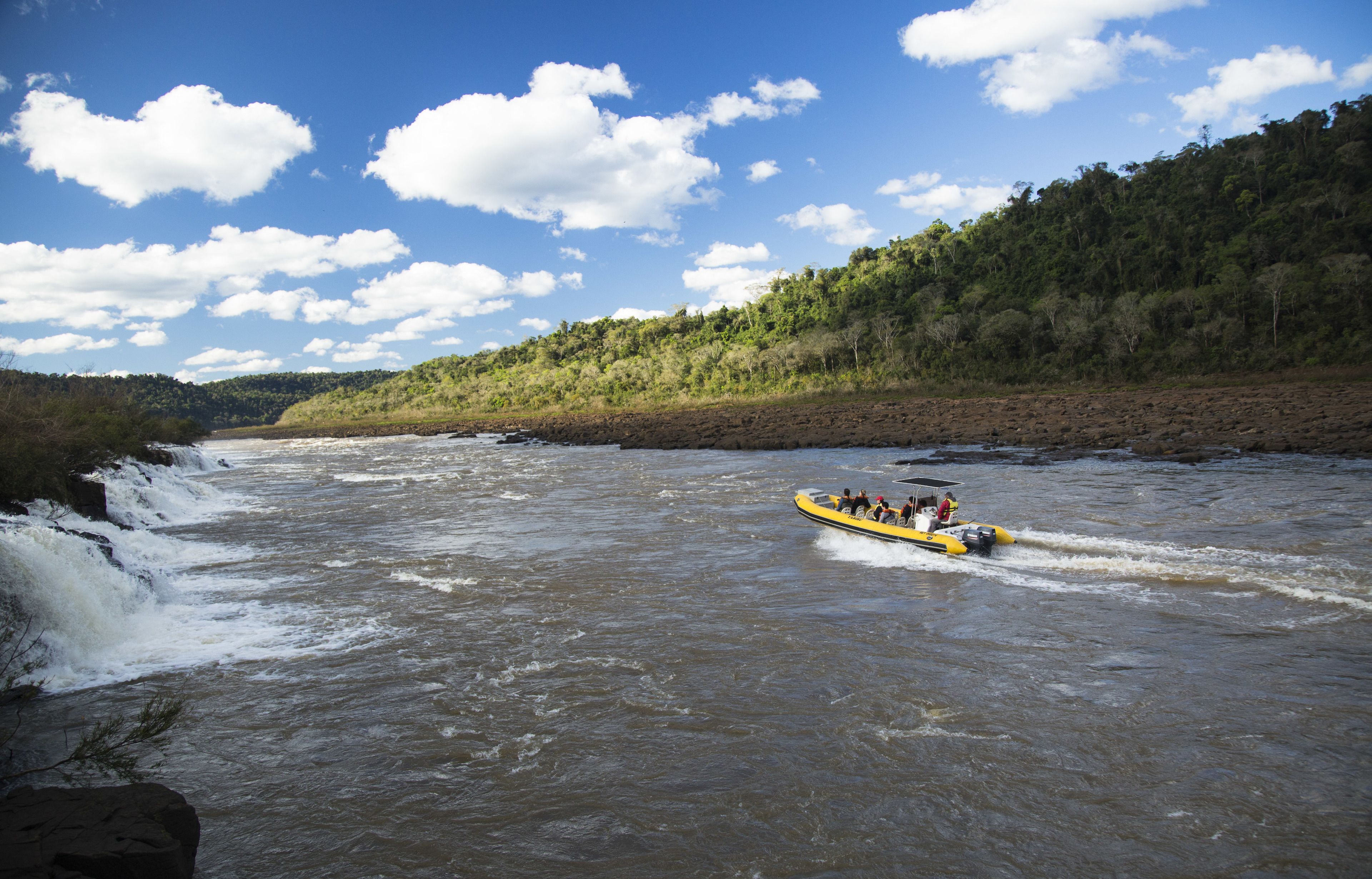 A river with a raft carrying people.