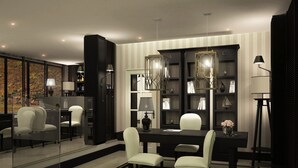 Un comedor moderno con un separador de vidrio, paredes a rayas blancas y negras, y un candelabro.