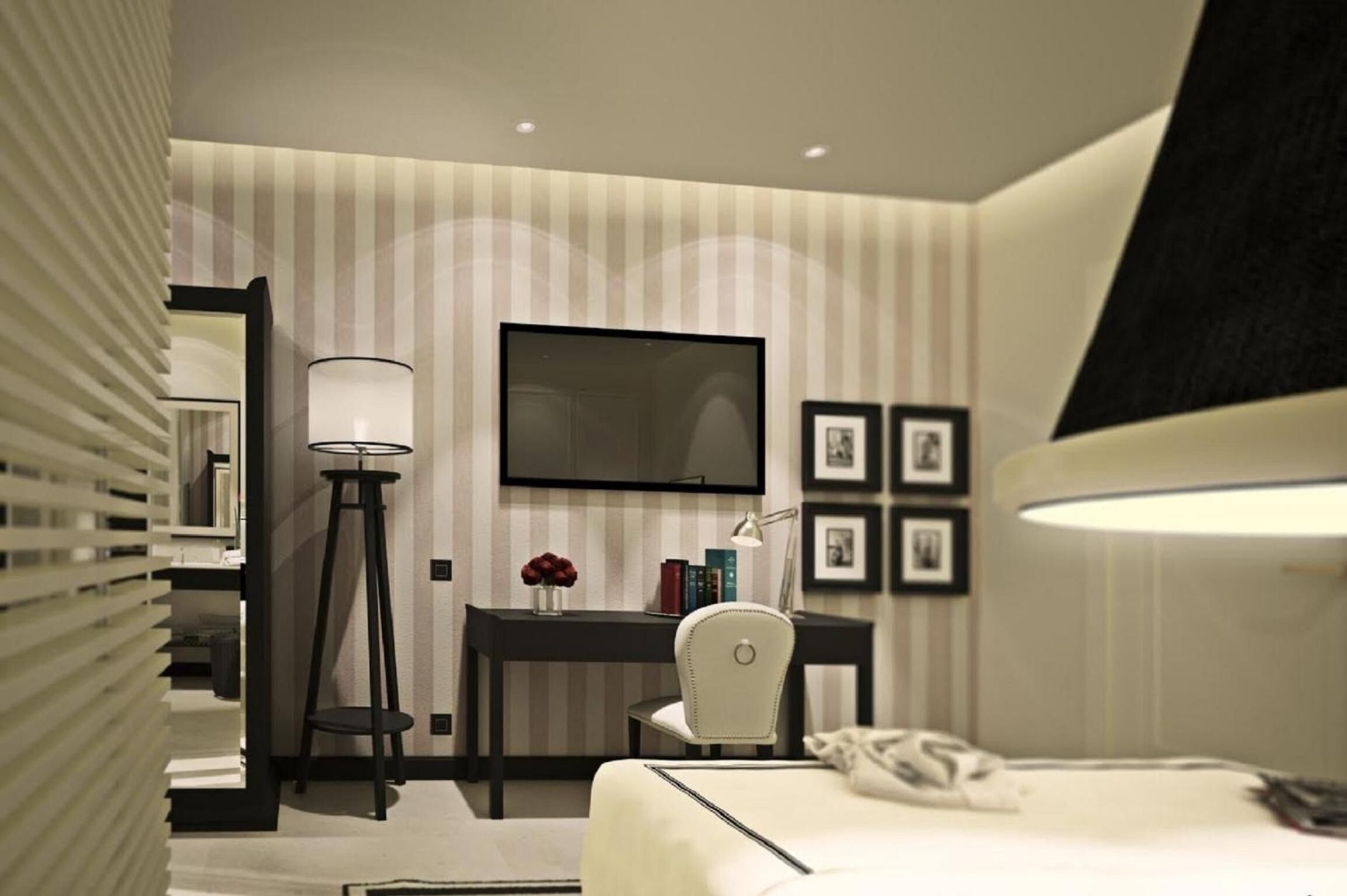 Une chambre d’hôtel moderne, équipée d’un lit, d’un bureau, d’une chaise, d’une lampe, d’un téléviseur et de tableaux encadrés au mur.