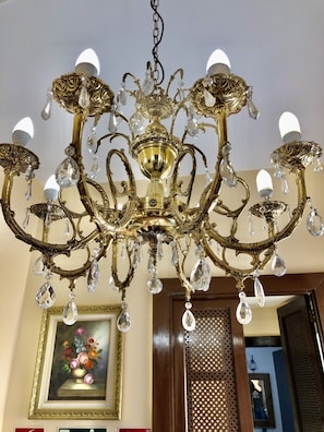 A chandelier with multiple arms and crystal decorations.