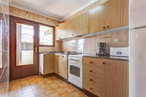 Full-size fridge, microwave, stovetop, cookware/dishes/utensils