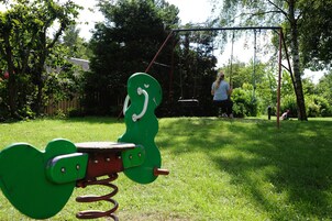 Un’area giochi con altalene a forma di cuore e altre altalene in un prato.