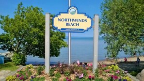 A sign for Northwinds Beach with a view of the beach and ocean. - 6 Bed Blue Mountain Chalets (The Blue Mountains)