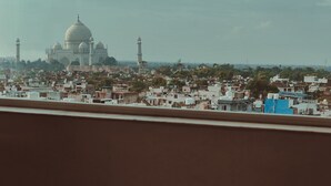 A view of the Taj Mahal from a window overlooking a cityscape. - Radisson Hotel Agra (Agra)