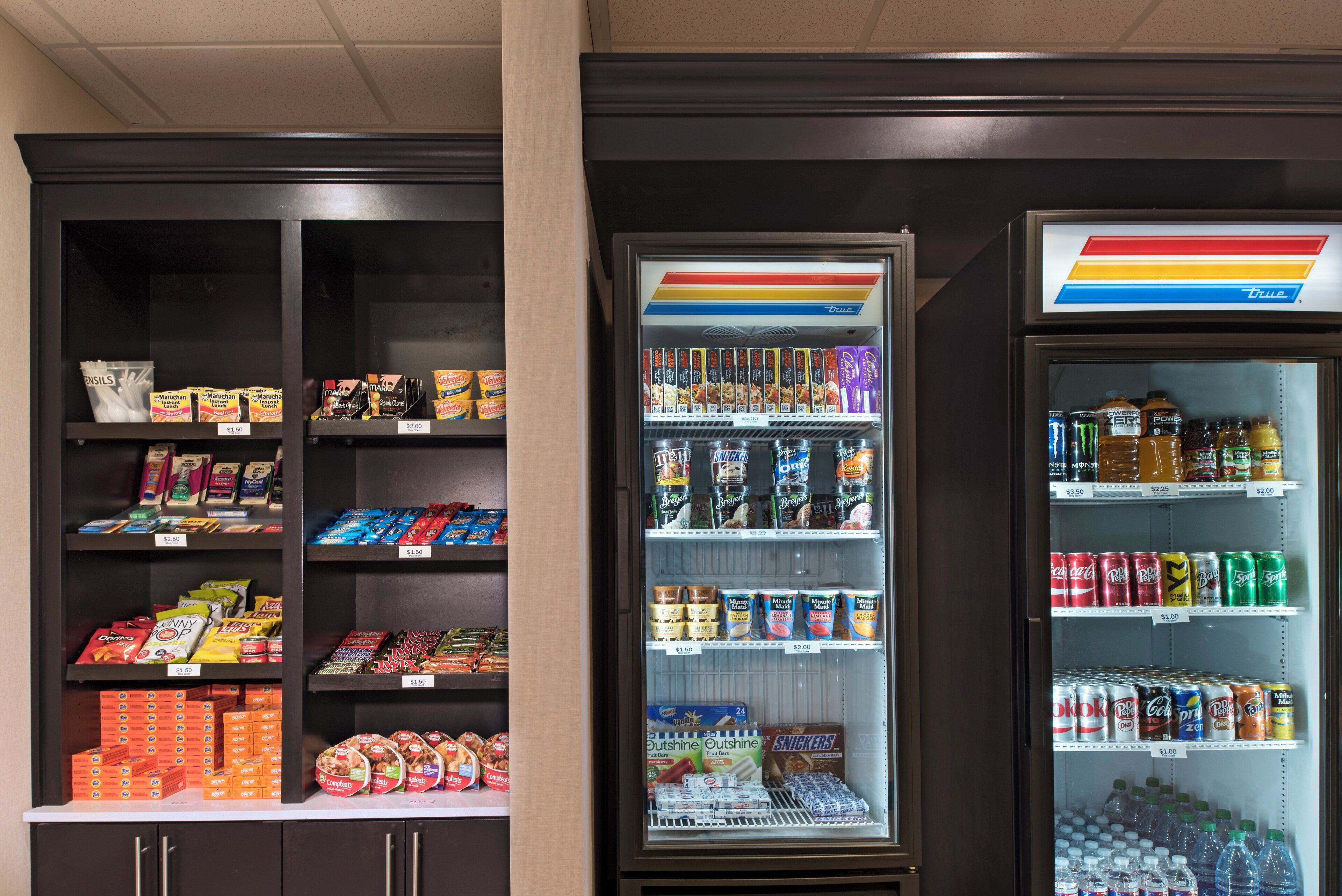 Máquina expendedora con diferentes snacks y bebidas, incluyendo Doritos, Snickers y refrescos.