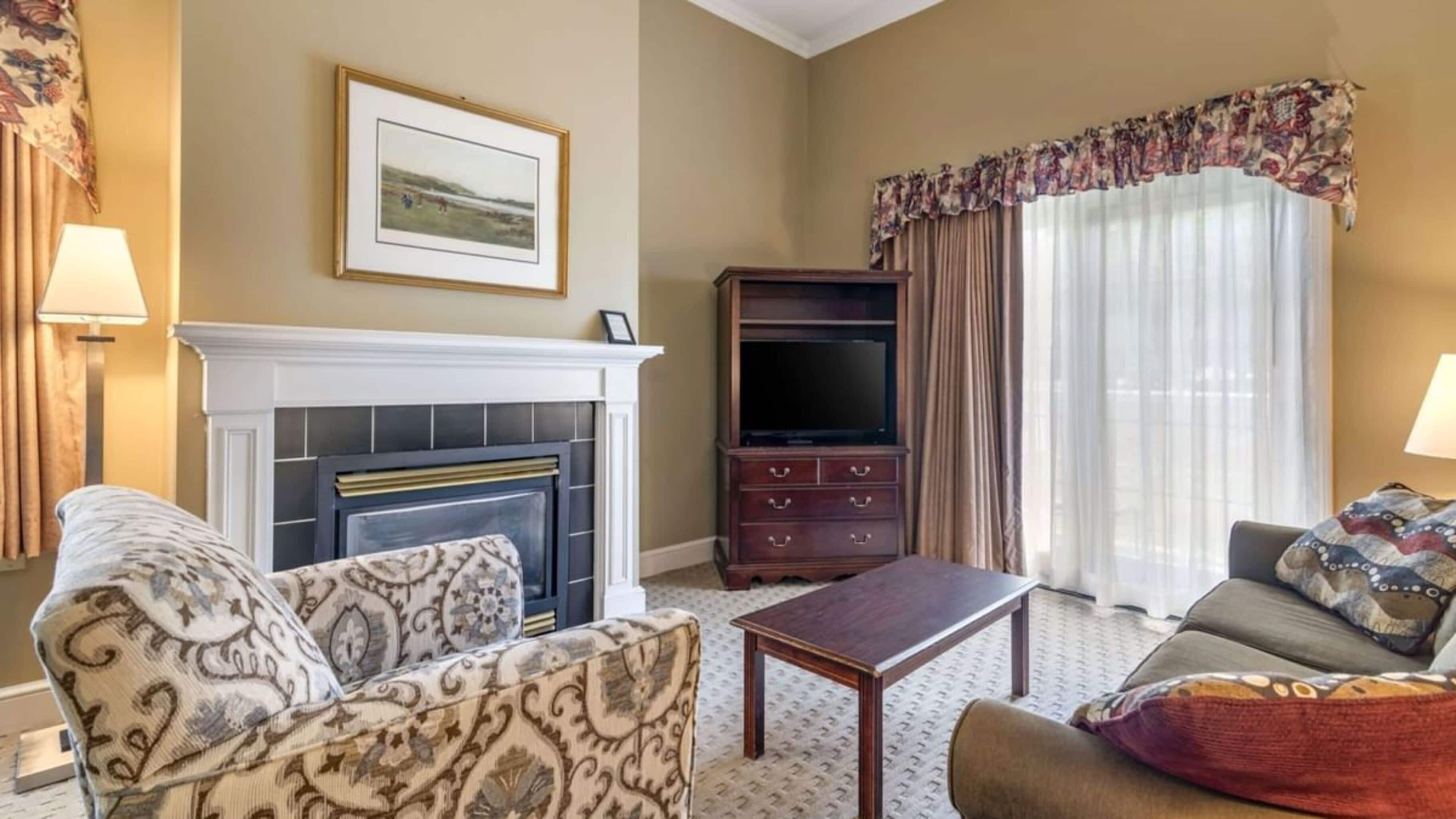 A living room with a fireplace, a television, and a sofa.