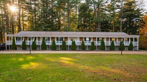 A two-story motel with a central corridor and individual rooms on either side. - The Inn at the Rostay (Bethel)