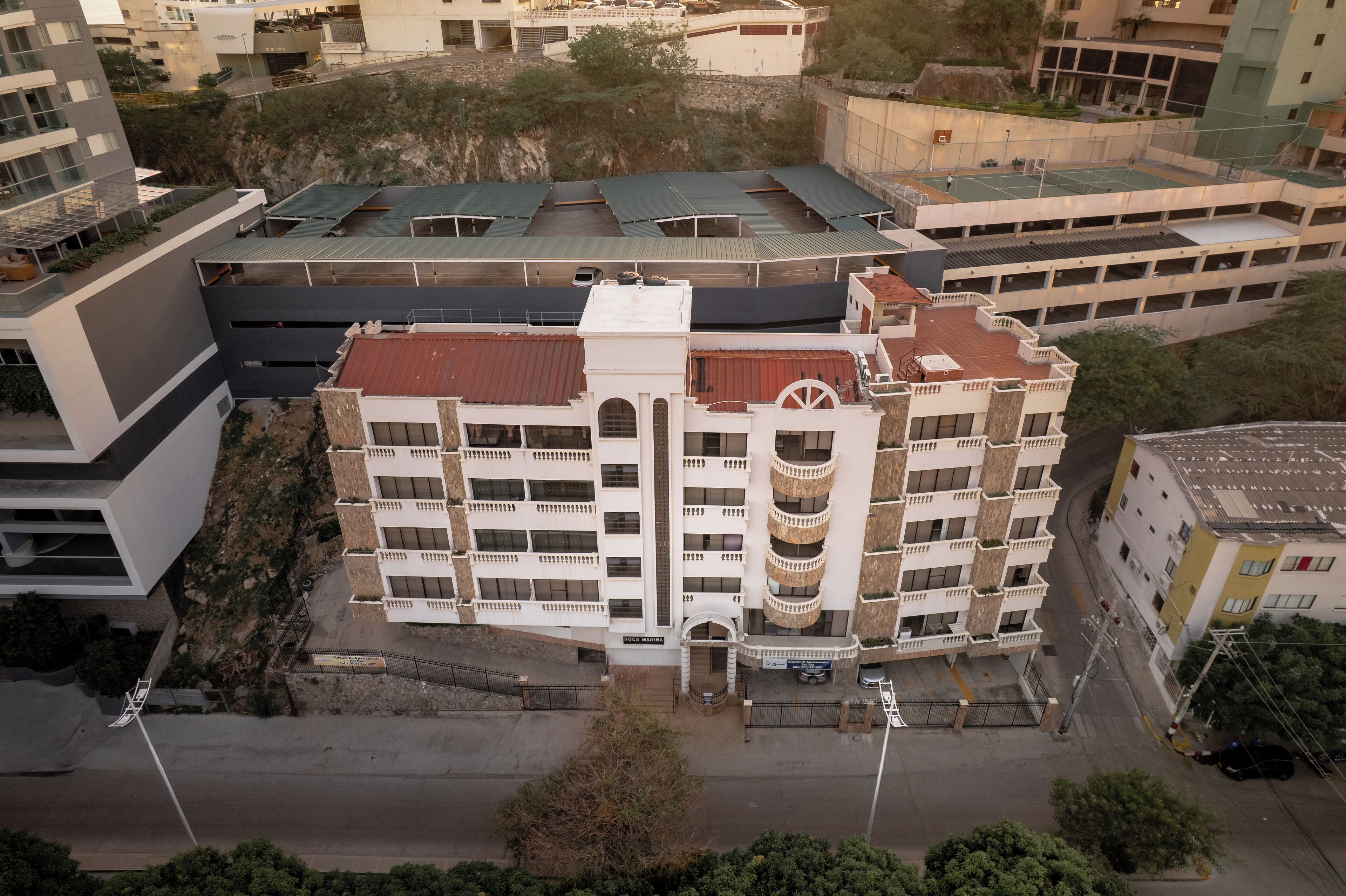 A multi-story building with a central courtyard, balconies, and a mix of architectural styles.