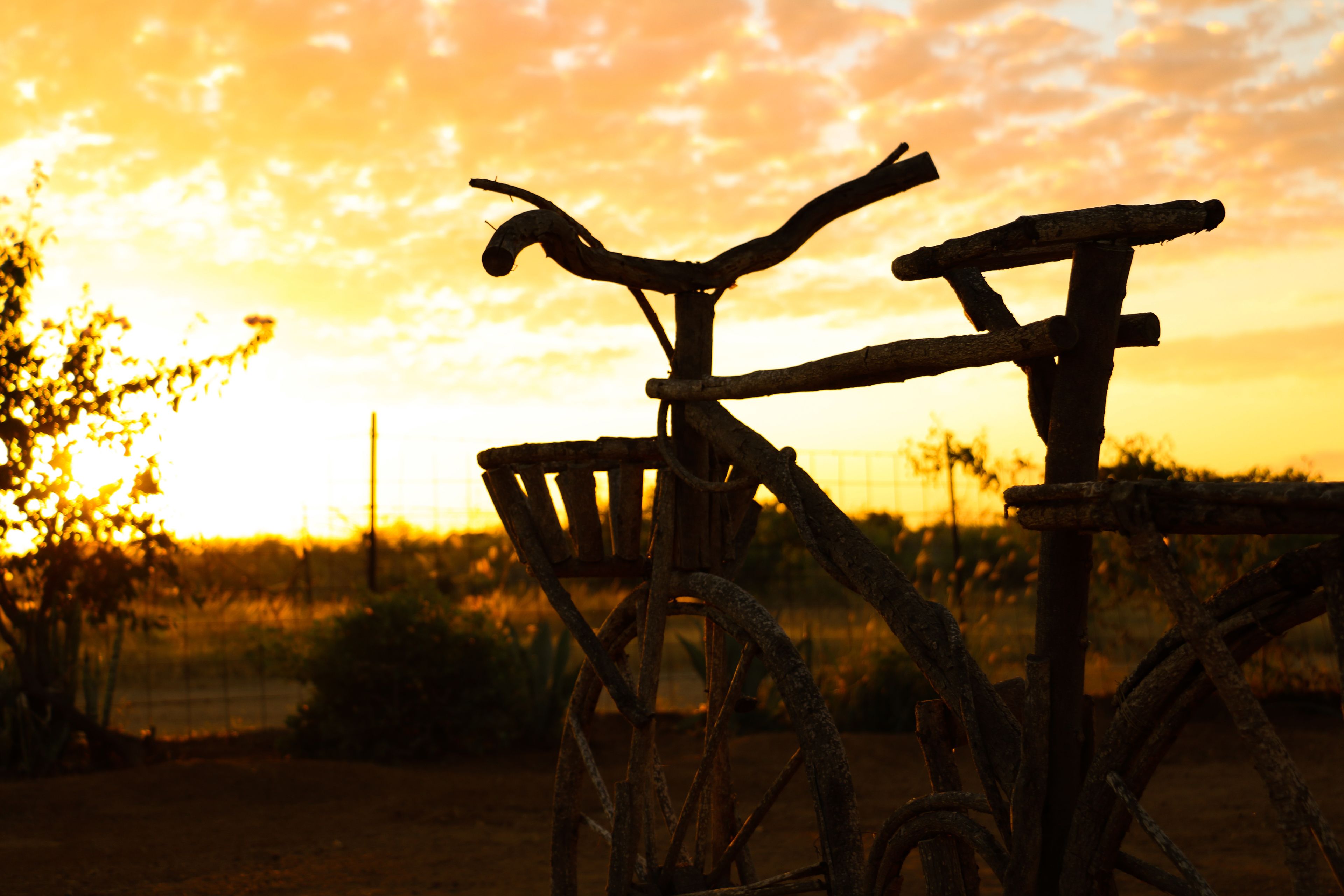 Een eenvoudige fiets met een mandje, voor een zonsondergang.