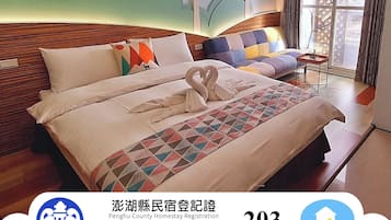 A hotel room with a bed, a small table, and a window with curtains.