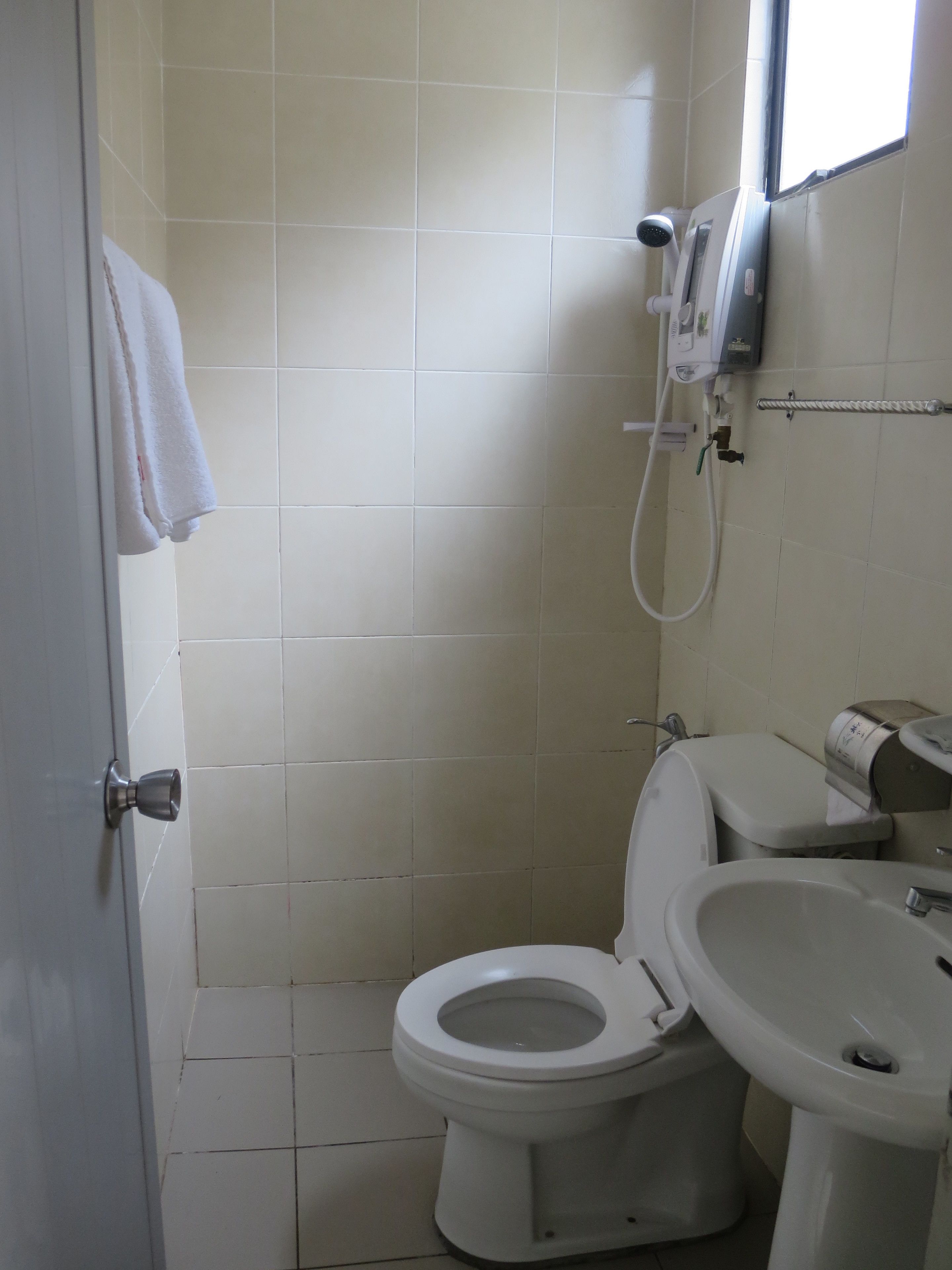 A small, clean bathroom with a toilet, bidet, and sink.