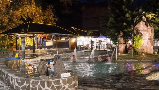 A hot spring area with stone pools and a covered pavilion. - Rainbow Resort (Taimali)