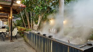 A hot spring area with wooden benches and a wooden deck. - Rainbow Resort (Taimali)