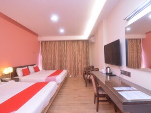 A hotel room with two beds, a wooden desk, a television, and a large window with curtains. - Nova Kuching Hotel (Kuching)