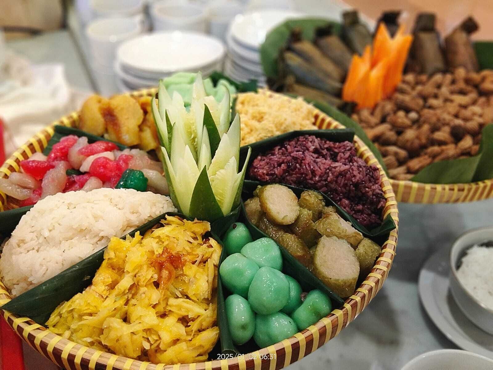 A variety of food items arranged on a table, including rice, vegetables, and other dishes.