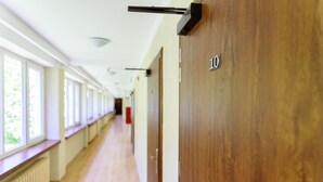 A hallway with wooden floors, a radiator, and a door labeled "10".