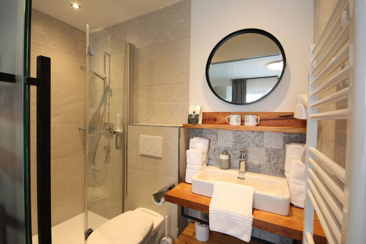 economy double room (partially with balcony) | bathroom | shower, hair dryer, towels