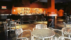 A bar area with stools and a round table with chairs. - Becket Court - University of Kent - Campus Accommodation (Canterbury)