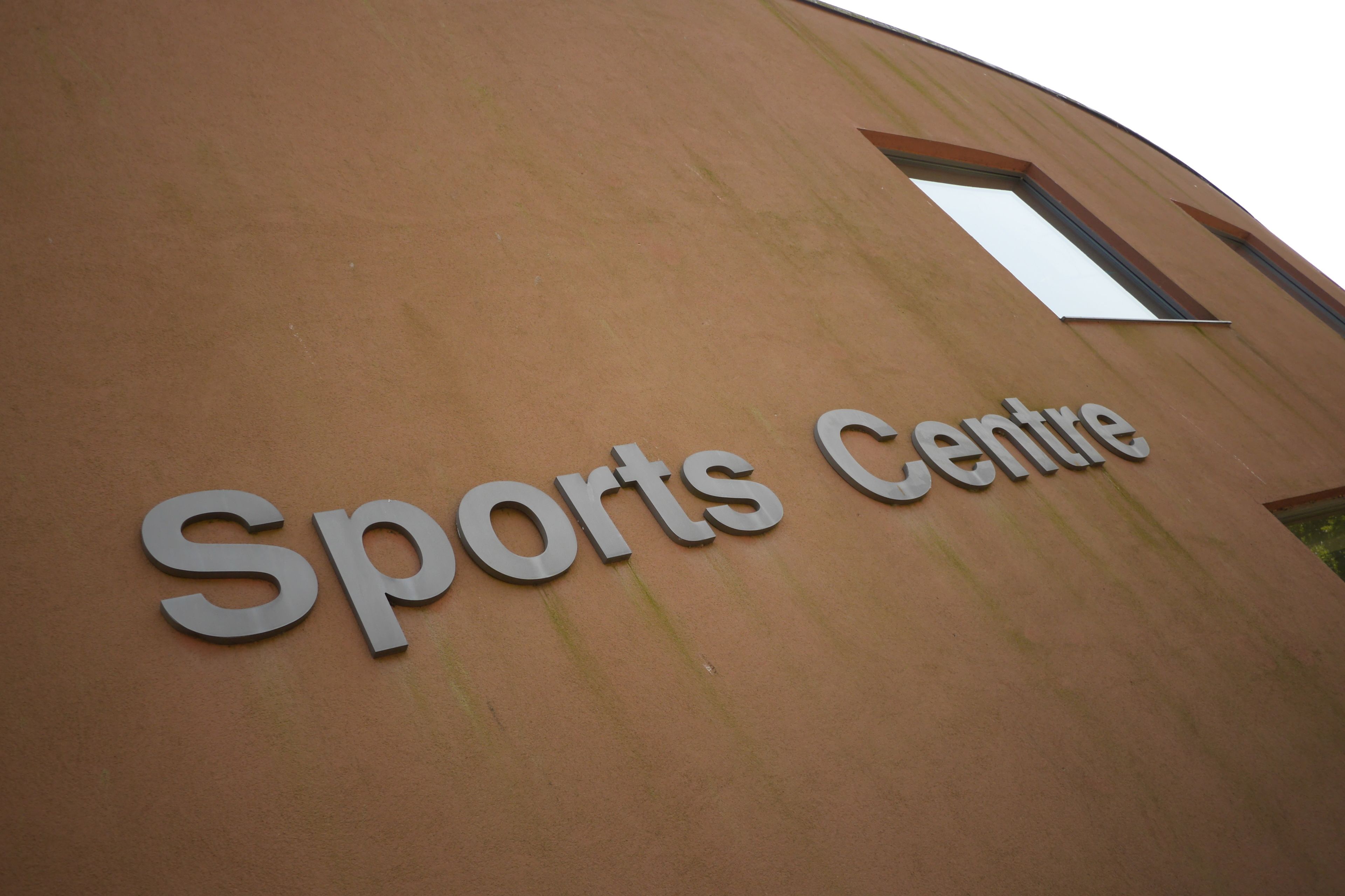 A building with a sign that reads "Sports Centre".