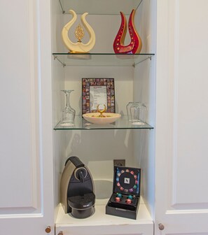 A display cabinet with decorative items, a framed menu, and a music player.
