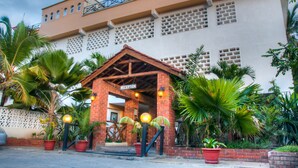A building with a reception area, brick walls, and potted plants.