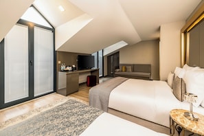 A modern hotel room with a large bed, a desk, a television, and a sliding door. - Peyk Hotel Sultanahmet (Istanbul)
