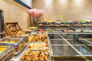 A buffet with various food items, including fruits, vegetables, and pastries. - Peyk Hotel Sultanahmet (Istanbul)