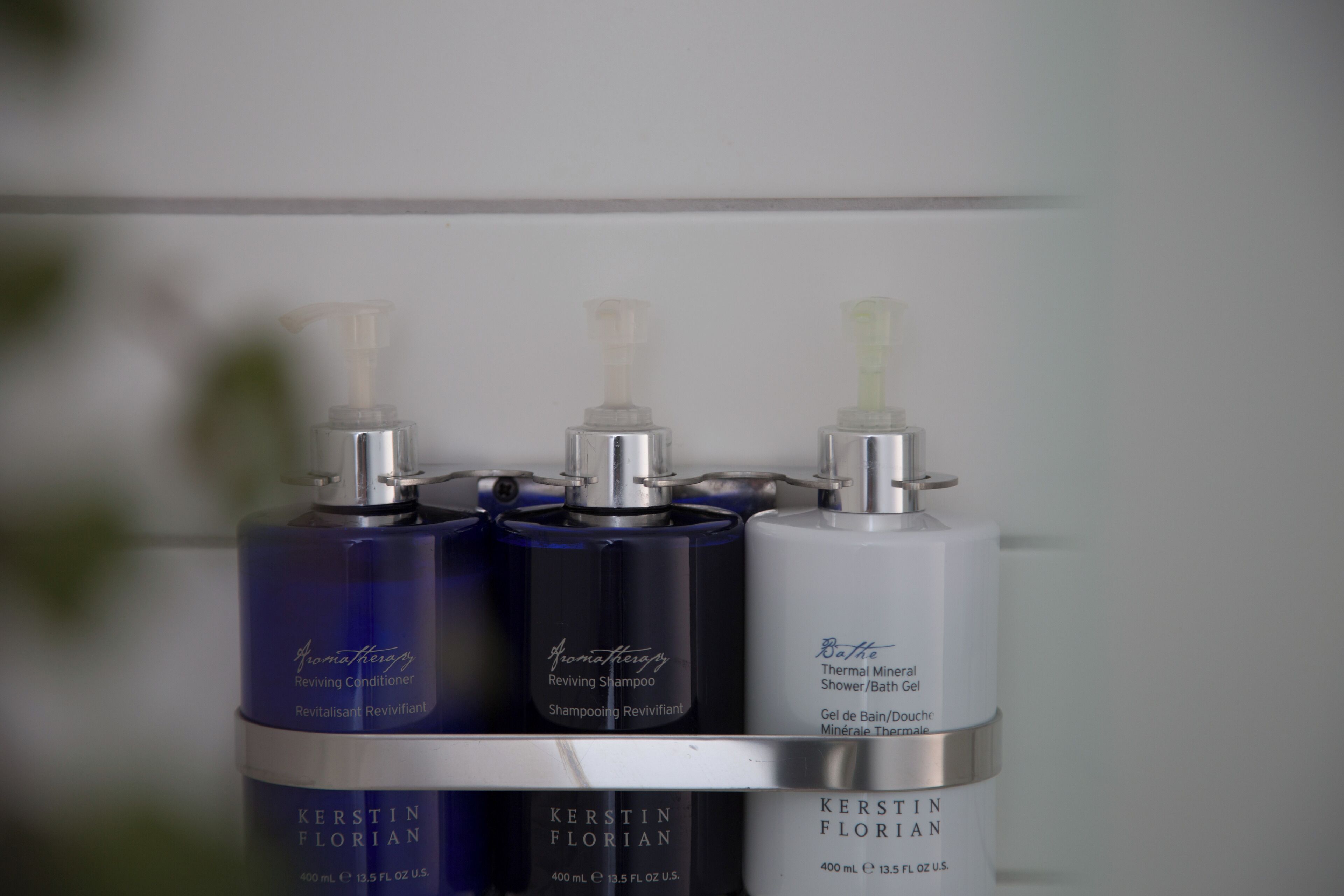 designer toiletries, hair dryer, slippers, towels