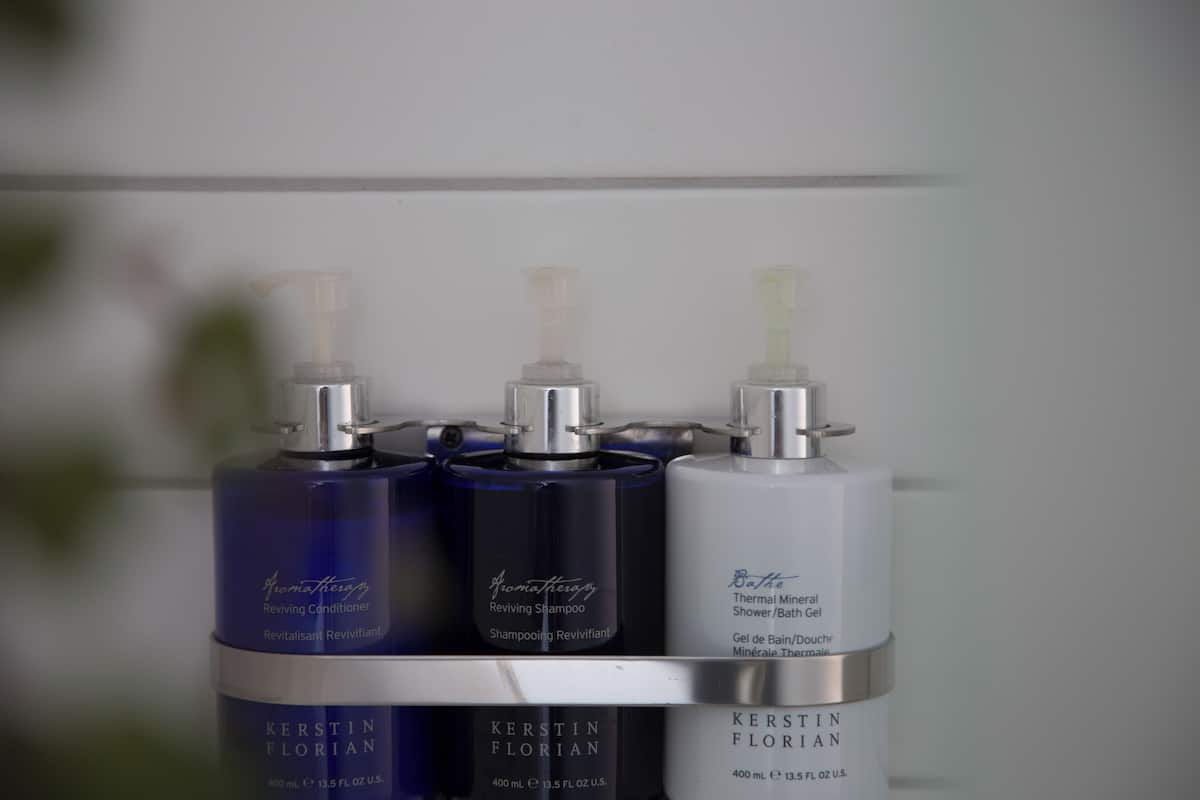 designer toiletries, hair dryer, slippers, towels