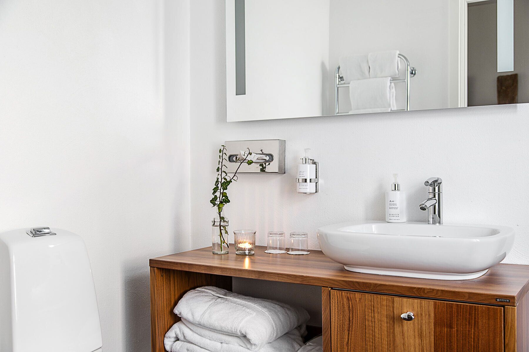 designer toiletries, hair dryer, slippers, towels