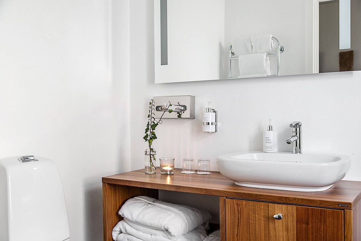 designer toiletries, hair dryer, slippers, towels