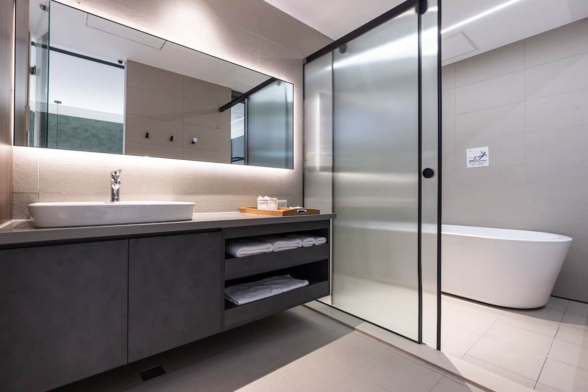 separate bathtub and shower, rainfall showerhead, hair dryer, slippers