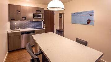 A modern kitchen with wooden cabinets, a built-in microwave, and a dishwasher.
