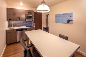 A modern kitchen with wooden cabinets, a built-in microwave, and a dishwasher.
