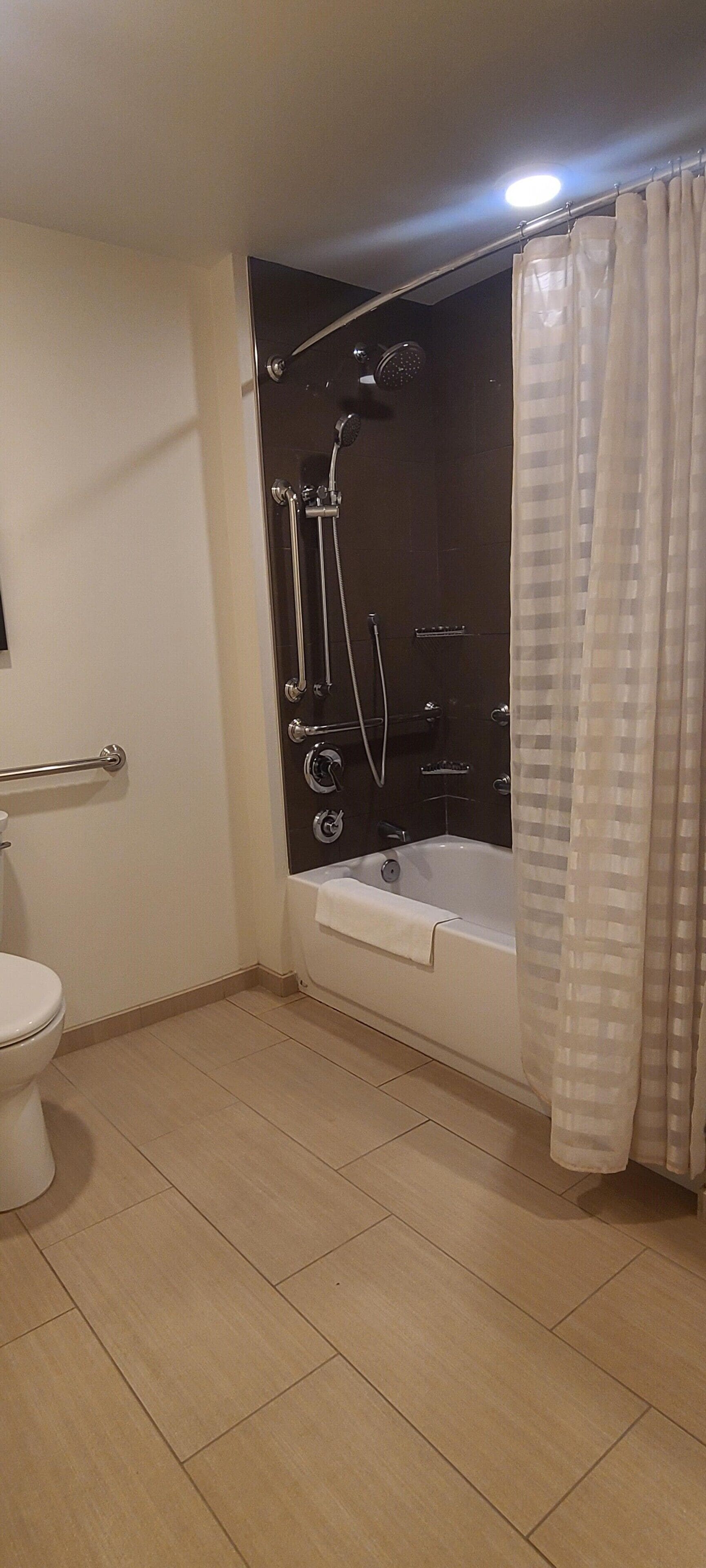 suite, 1 bedroom, accessible, bathtub | bathroom | rainfall showerhead, designer toiletries, hair dryer, towels