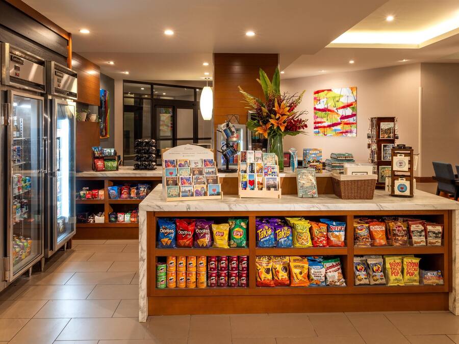 A snack bar with various packaged snacks and a coffee machine.