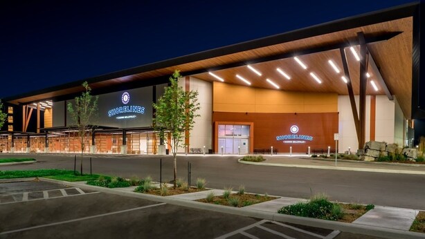 A modern building with a prominent 'Shorelines' sign, featuring a large entrance and a covered area with a sloped roof. - Moira Lake Motel (Madoc)