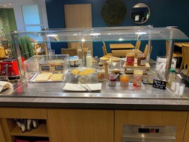 A breakfast buffet with various food items and condiments.