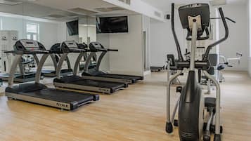 A gym with treadmills, a stationary bike, and a weight machine.