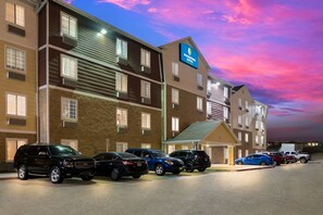 Ein mehrstöckiges Hotel mit Parkplatz.