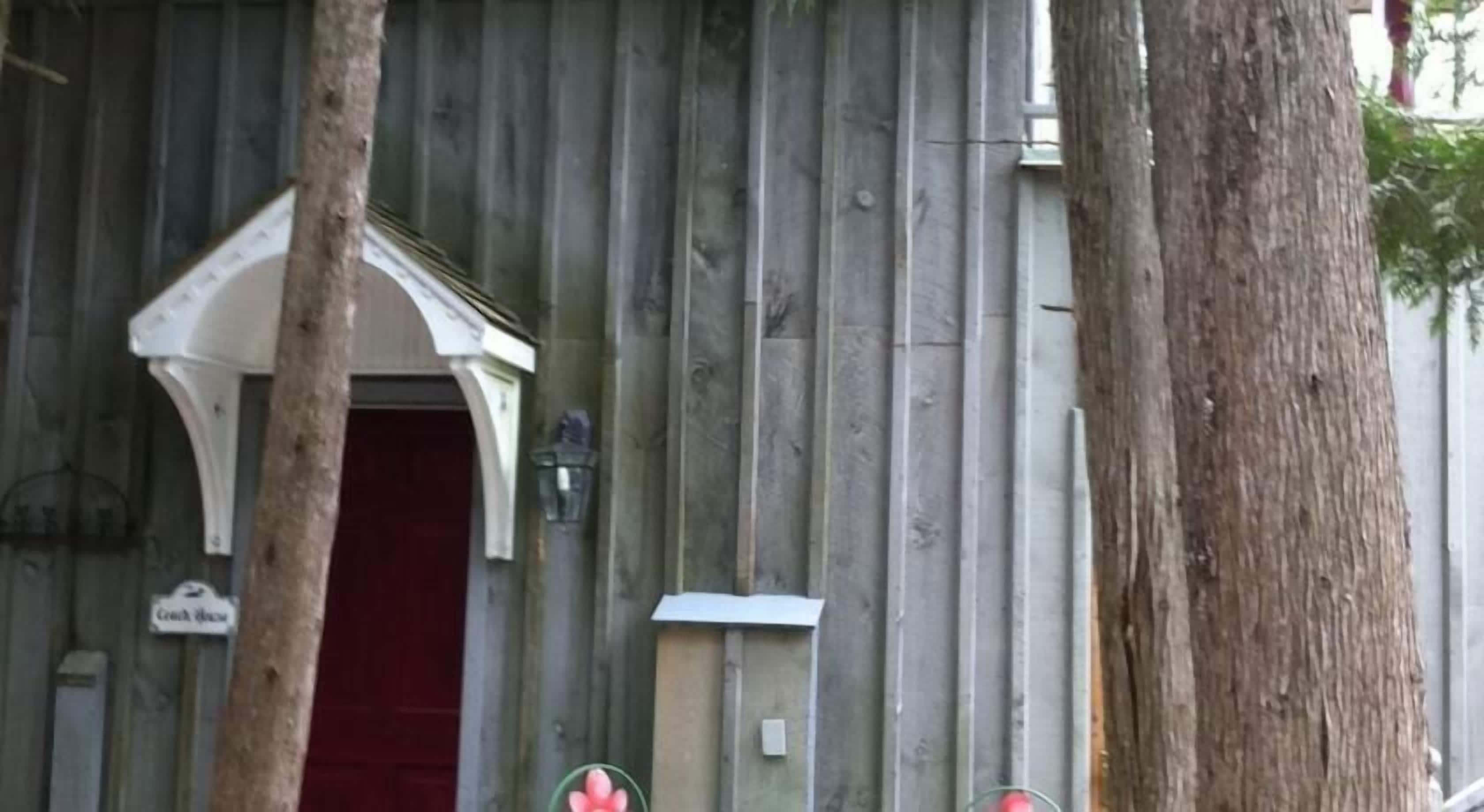 A building with a red door and a small porch.