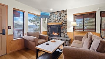 Standard Condo, 1 Queen Bed, Fireplace, Lake View | Living area | 42-inch flat-screen TV with cable channels, fireplace, books