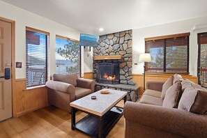 Standard Condo, 1 Queen Bed, Fireplace, Lake View | Living area | 42-inch flat-screen TV with cable channels, fireplace, books