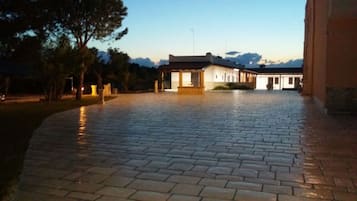 A paved courtyard with a building in the background.
