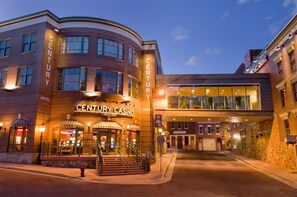A brick building with a curved facade, a sign reading "CENTURY CASINO," and a modern glass entrance.