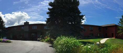 A large, multi-story building with a brick exterior and a central courtyard.