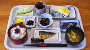 A tray with various Japanese dishes including rice, fish, and soup. - Toyooka Park Hotel (Toyooka)