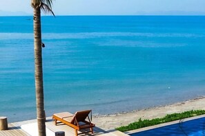 A beach view with a lounge chair and a pool. - Bari Lamai Resort (Rayong)